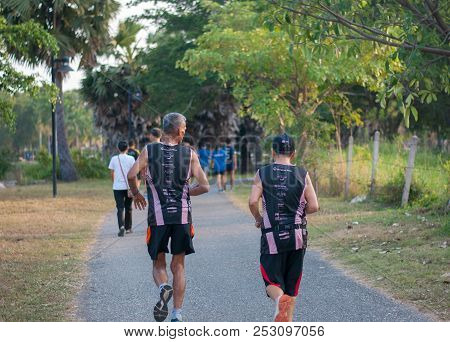 Sattahip, Chonburi, Thailand - February 09, 2018: Two Old Friends Running Together On The Path In Pa