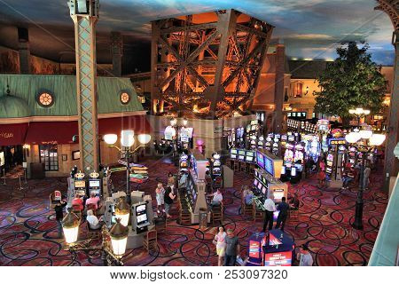 Las Vegas, Usa - April 14, 2014: People Play Slots At Paris Las Vegas Casino. The Resort Was Opened 
