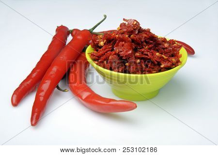 Red chilly chutney and chilies on white background. a rural food item in India.
