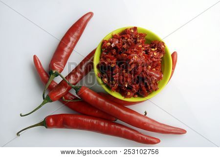 Red chilly chutney and chilies on white background. a rural food item in India.