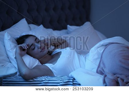 Young Woman Sleeping In Bed At Night. Sleeping Time