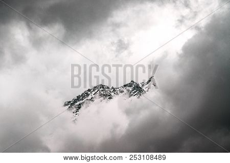 Snow-covered Mountains Of The Himalayas In The Clouds At The Height Of
