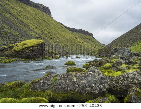 View On Blue Water Stream And Green Moss Covered Stones And Hills In Eldgja Gorge In Iceland Fjallab