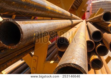Rusty Metal Rolled Steel Lies On A Rack In The Open Air On A Bright Sunny Day.