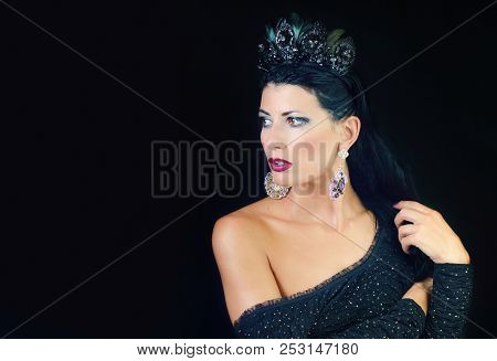 A Girl In A Black Dress And A Crown On Her Head