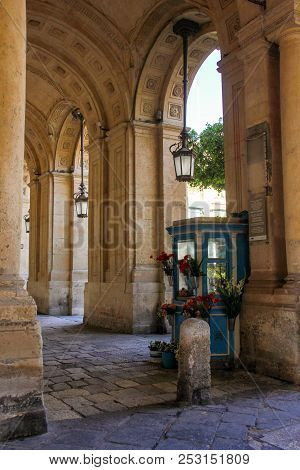 Old Small Cute Flower Shop Between Column Of Beautiful Building