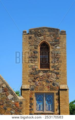 Stone Bell Tower Of The Huntsville United Methodist Church Is Framed By Sunny Blue Skies.  Huntsvill