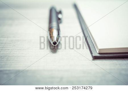 Biro Beside An Empty Notepad On A Table