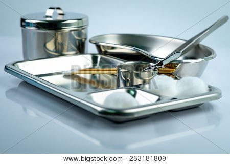 Wound Care Dressing Set On Stainless Steel Plate. White Cotton Ball, Cotton Stick, Forceps, Kidney B