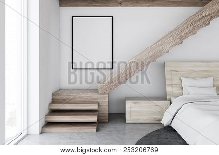 Scandinavian Style Bedroom Interior With White Walls, A Concrete Floor With A Carpet, Stairs, And A 