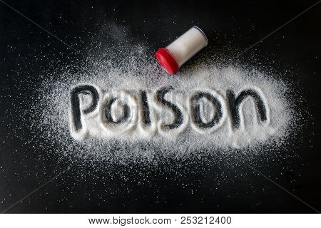 Salt Scattered On Black Surface. Written Word- Poison. Concept- Healthy Food, Diet, Harm To Health F