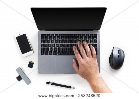 Top View Of Men's Hand On Laptop, Mobile Phone, Memory Cards, Card Reader, Pen And Mouse