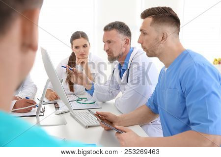 Group Of Doctors Attending Meeting In Clinic. Cardiology Conference