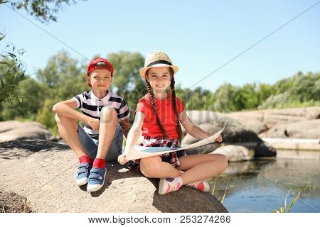 Little Children With Map Outdoors. Summer Camp