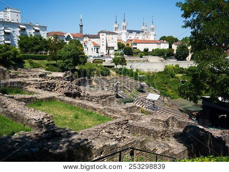 The Ancient Roman Theatre Of Fourviere And The Basilica Of Notre-dame De Fourviere In Background In 