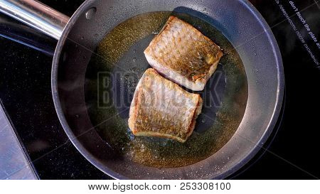 Pan-fried Fish, Two Pieces Of Loban Fillet On The Steaming Frying Pan.