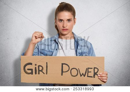 Lovely Confident Young Woman With Serious Expression, Shows Fists, Demonstares Her Power, Belongs To