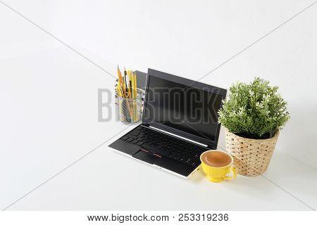Workspace With Laptop Computer, Office Supplies,plant Decoration On Office Table At Home Or Studio. 