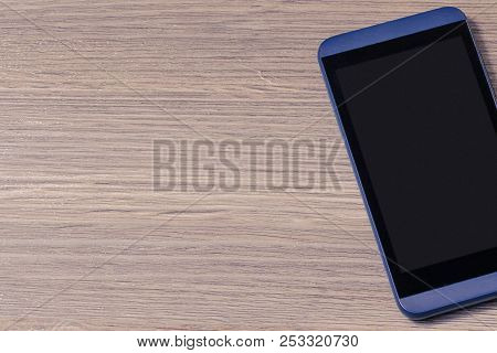 Mobile Pnone On A Wooden Background Isolated On Wooden Bright Brown Background