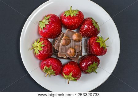 Plate Full Of Tasty Juicy Strawberries And Chocolate Isolated On Black Background