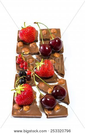 Vertical Photo Of Chocolate Bar Rich In Hazelnuts With Different Fruit On It. Isolated On White Back