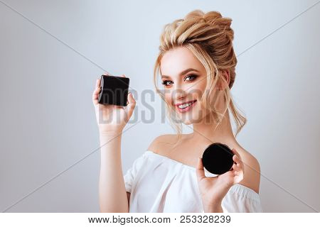 Fashion Glamour Portrait Of Happy Smiling Blonde Woman Long Wavy Hair Style Holding Cosmetics Over L