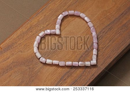 Pink Heart On A Wooden Background. Kunzite Is A Natural Pink Stone For Creating Jewelry. Natural Cry