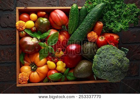 Organic Vegetable Box With Large, Cherry Tomatoes, Basil, Cucumbers, Red Onions, Broccoli And Avocad