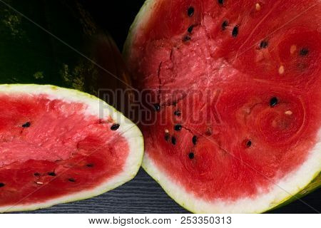 One Watermelon Cut In Halves Isolated On Black Background With Clipping Path