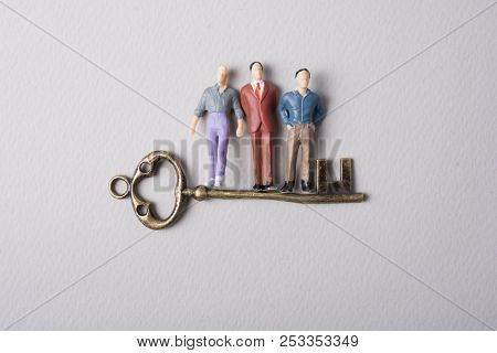 Tiny Figurine Of Man Miniature And Retro Key