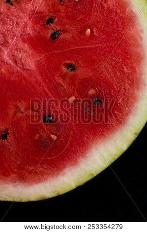 A Half Of Fresh Watermelon Isolated On Black Background.