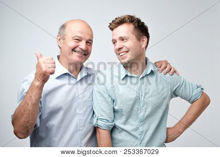 Senior Father Is Proud Of His Mature Son.