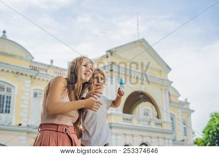 Mom And Son On Background Of Old Town Hall In George Town In Penang, Malaysia. The Foundation Stone 