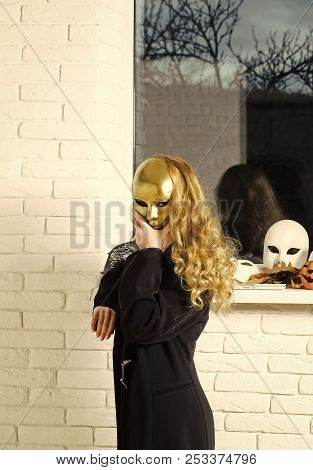 Woman Or Girl Cover Face With Golden Mask With Long Blond Hair At Window. Carnival, Masquerade, Masq