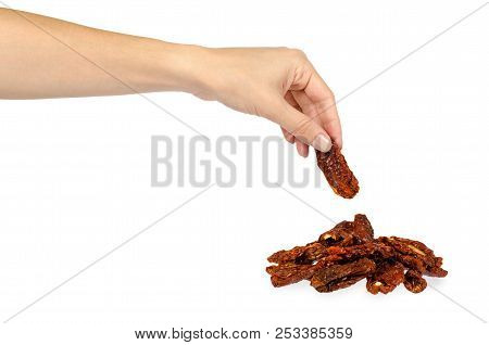 Sun Dried Red Tomatoes With Hand Isolated On White Background