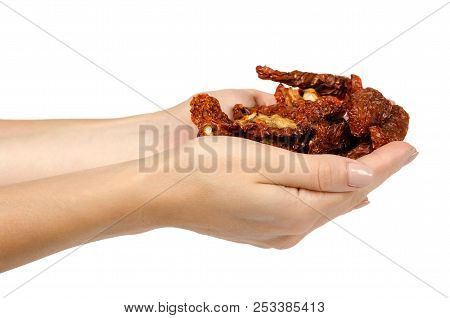 Sun Dried Red Tomatoes With Hand Isolated On White Background