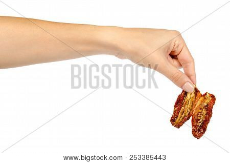 Sun Dried Red Tomatoes With Hand Isolated On White Background