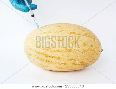Melon On A White Background In Which Enter Gmo And Nitrates, Close-up, Genetically Modified Organism