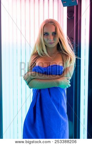 Blonde Wrapped In Towel Near Sunroom View