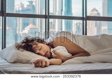 Man Wakes Up In The Morning In An Apartment In The Downtown Area With A View Of The Skyscrapers. Lif