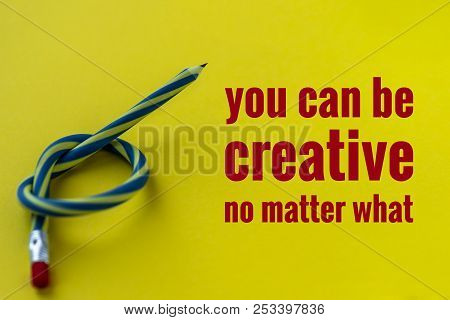 Knotted Striped Pencil With Pink Erazer Lying On Yellow Background, Text You Can Be Creative No Matt
