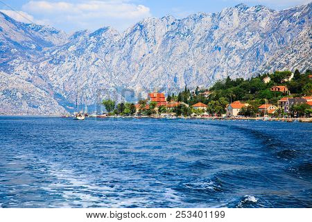 Waterfront Of Small Town Dobrota Along Bay Of Kotor, Montenegro. View Of Coastal Villas, Gardens And
