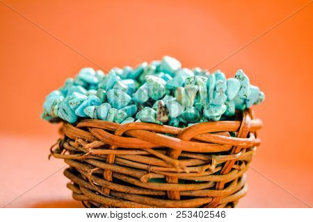 Pile Stones Of Raw Turquoise In Small Wooden Nest On A Brown Background. Blue And Green Color Stones