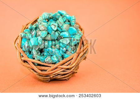 Pile Stones Of Raw Turquoise In Small Wooden Nest On A Brown Background. Blue And Green Color Stones