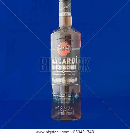 Studio Shot A Bottle Of Bacardi Black Rum Isolated On Blue Background