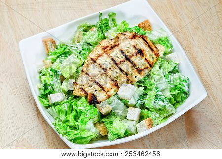 Roasted Black Pepper Lamb Steak With Salads And Fries On A Blue Round Plate. Wooden Texture Backgrou