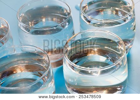 Glass Of Water On Pastel Blue. Close Up. Water Balance For Healthy.