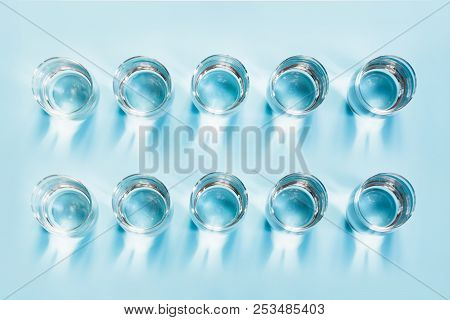 Ten Glass Of Water On Blue Table. Daily Rate. Norm Of Day For Healthy And Detox.