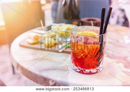 Mezcal Negroni Cocktail Italian Aperitivo On The Table In The Open Area Of Restaurante