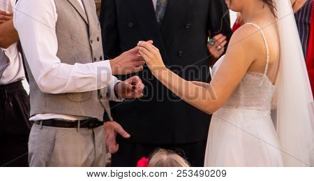 A Happy Bride Puts A Ring On The Jewish Rite On The Index Finger Of Her Fianc